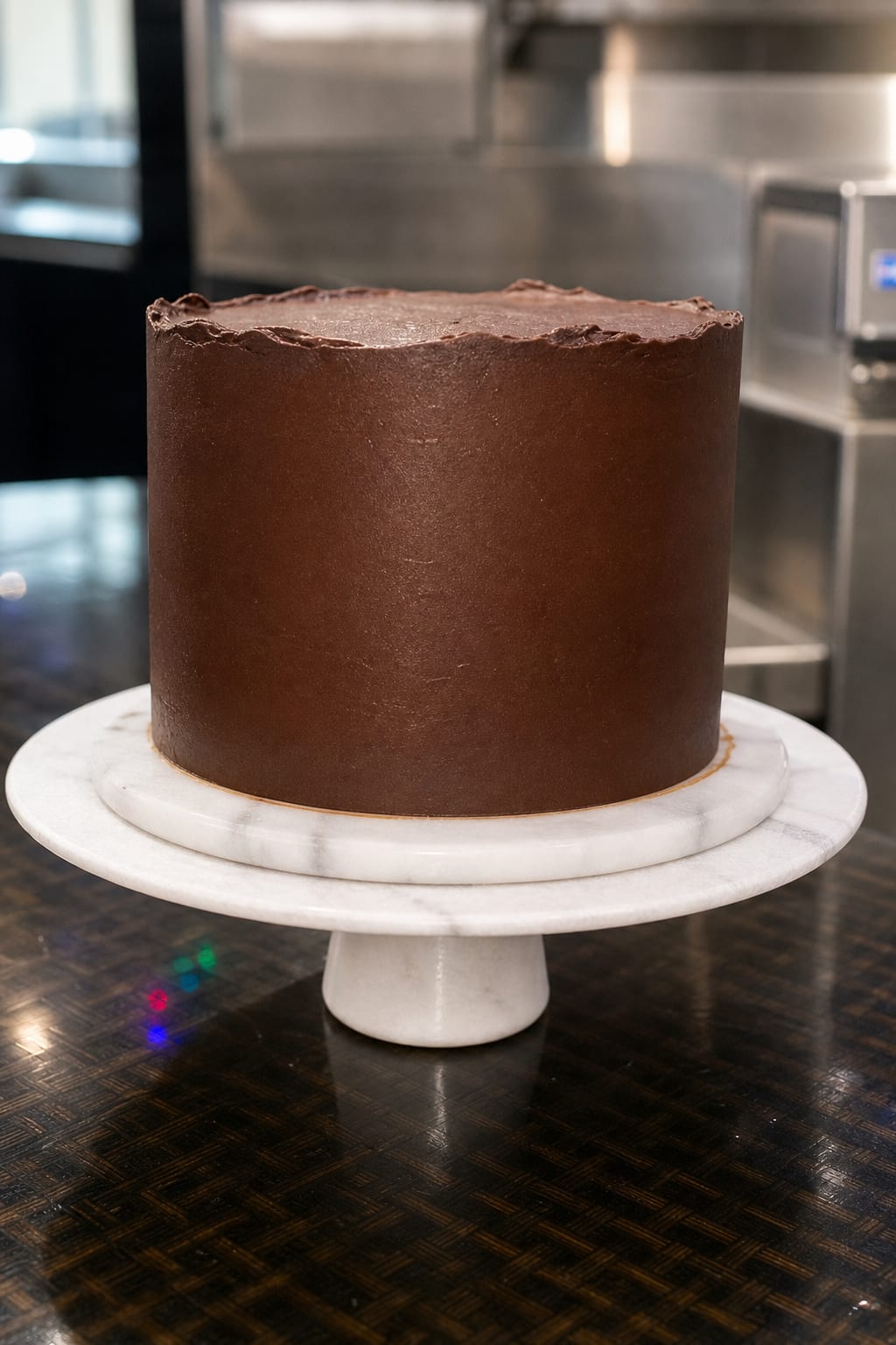 A beautiful plated slice of classic chocolate birthday layer cake showing its clean layers